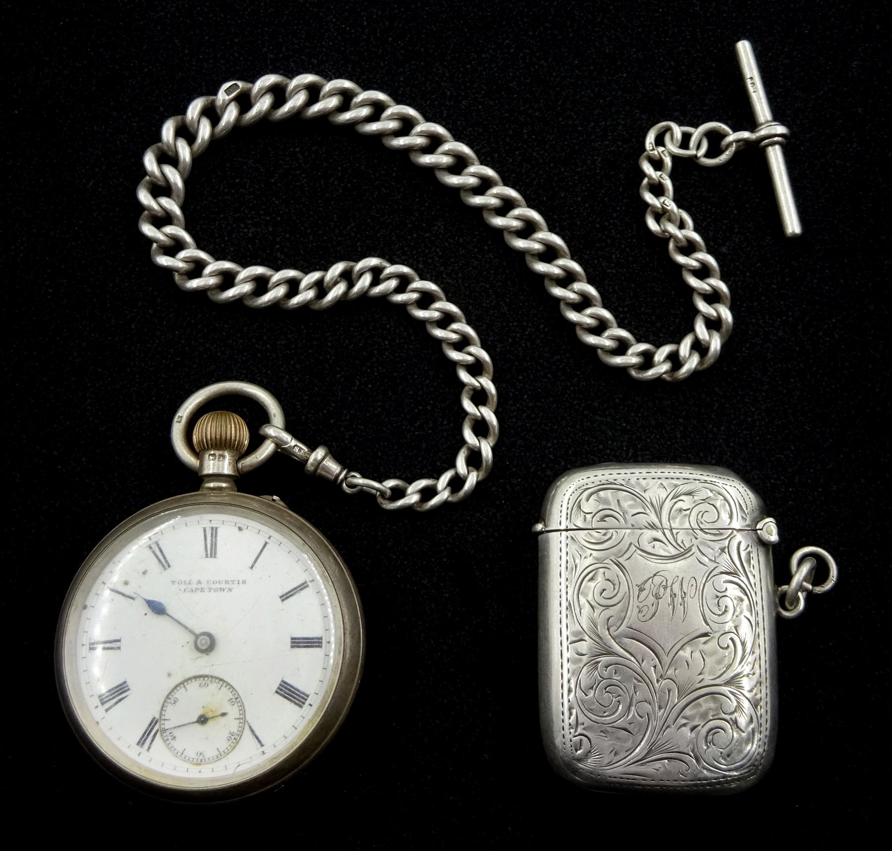 Silver open face keyless lever pocket watch by Toll & Courtis Cape Town, Chester 1900, with tapering silver Albert chain with t-bar and clip, by Joseph Sewill, Birmingham 1895 and silver lighter by Joseph Gloster Ltd, Birmingham 1911