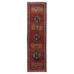 North East Persian Kurdie runner, the red field decorated with three serrated diamond meda...