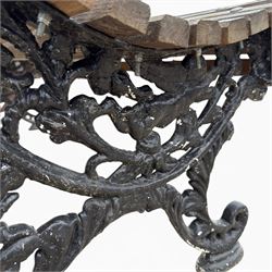 19th century cast iron and wood slatted garden bench, serpentine scroll form, ornate bow ends finished in green paint