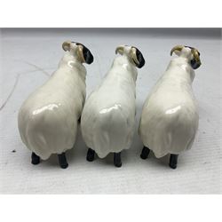 Seven Beswick figures of sheep comprising three ewes and four lambs, together with a figure of a sheepdog (8)