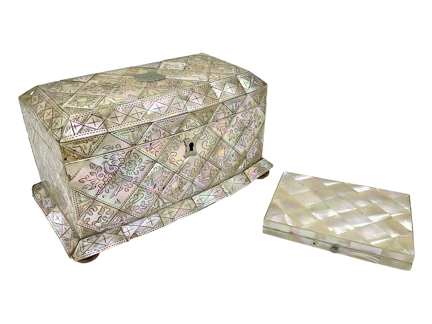 Victorian mother of pearl tea caddy, of rectangular bow-fronted form, the body with floral, bird and geometric engraved mother of pearl panels, white metal shield plaque to the cover inscribed with the initials G.J.A and similar escutcheon, the two division interior with ivory edging and two panelled mother of pearl lids, on four vegetable ivory bun feet L20cm, together with a similar style mother of pearl card case (2) This item has been registered for sale under Section 10 of the APHA Ivory Act