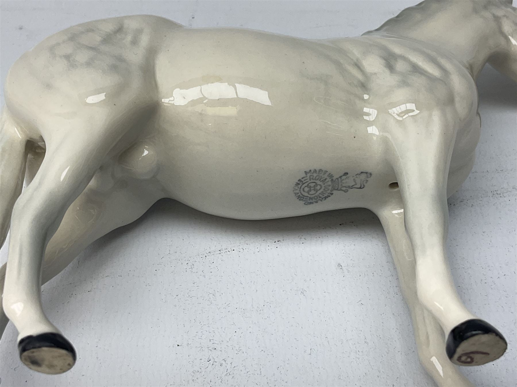 Collection of Beswick horses, including grey horse no.701, palomino foal no 836, grey stocky jogging mare no.855 etc, together two Royal Doulton horses, (8)