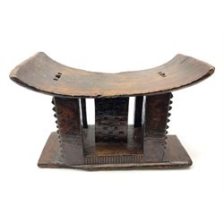 African headrest, raised on five small carved supports and a plinth base H30.5cm