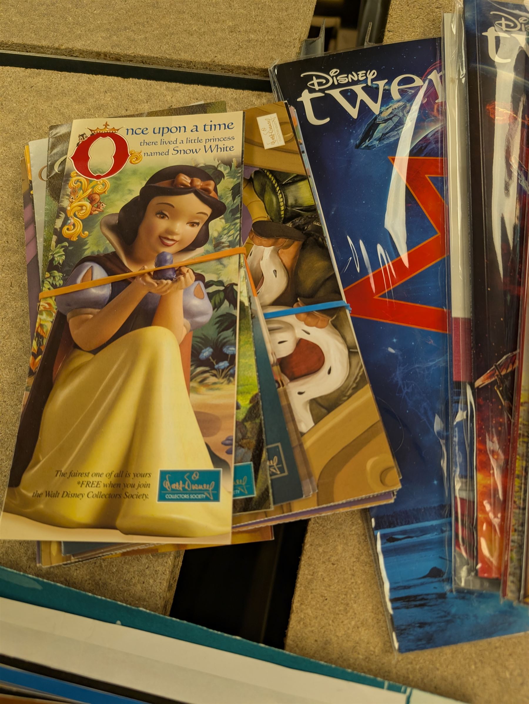 Collection of Disney memorabilia and ephemera, including Walt Disney Treasures DVD, two Disney Villains mugs, enamel pins, Mickey Mouse D23 fan club pack, Disney Twenty-Three magazines, Sketches magazines, etc