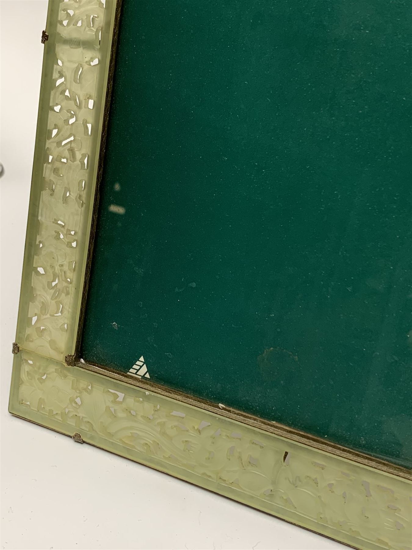 Early 20th century Chinese jade mounted photograph frame, of rectangular form the pierced jade frame carved with flowers and birds, the top panel carved with Foo dogs flaking an applied carved lavender coloured boss, with easel support verso, H33cm
