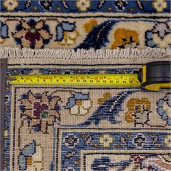 Central Persian Kashan hand-knotted runner, ivory field decorated with an elegant all-over scrolling vine design composed of finely drawn palmettes, floral strays and arabesques in a continuous lattice, principal border on an indigo ground decorated with palmette and vine scroll, flanked by multiple narrow guard stripes, with cotton fringe ends 