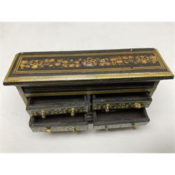 Collection of miniature dolls house furniture, to include five drawer chest painted with blossom, cream and gilt double door mirrored wardrobe, four piece lacquered style desk set, three piece suite, writing desk, wash stand, Knoll style sofa etc (14)