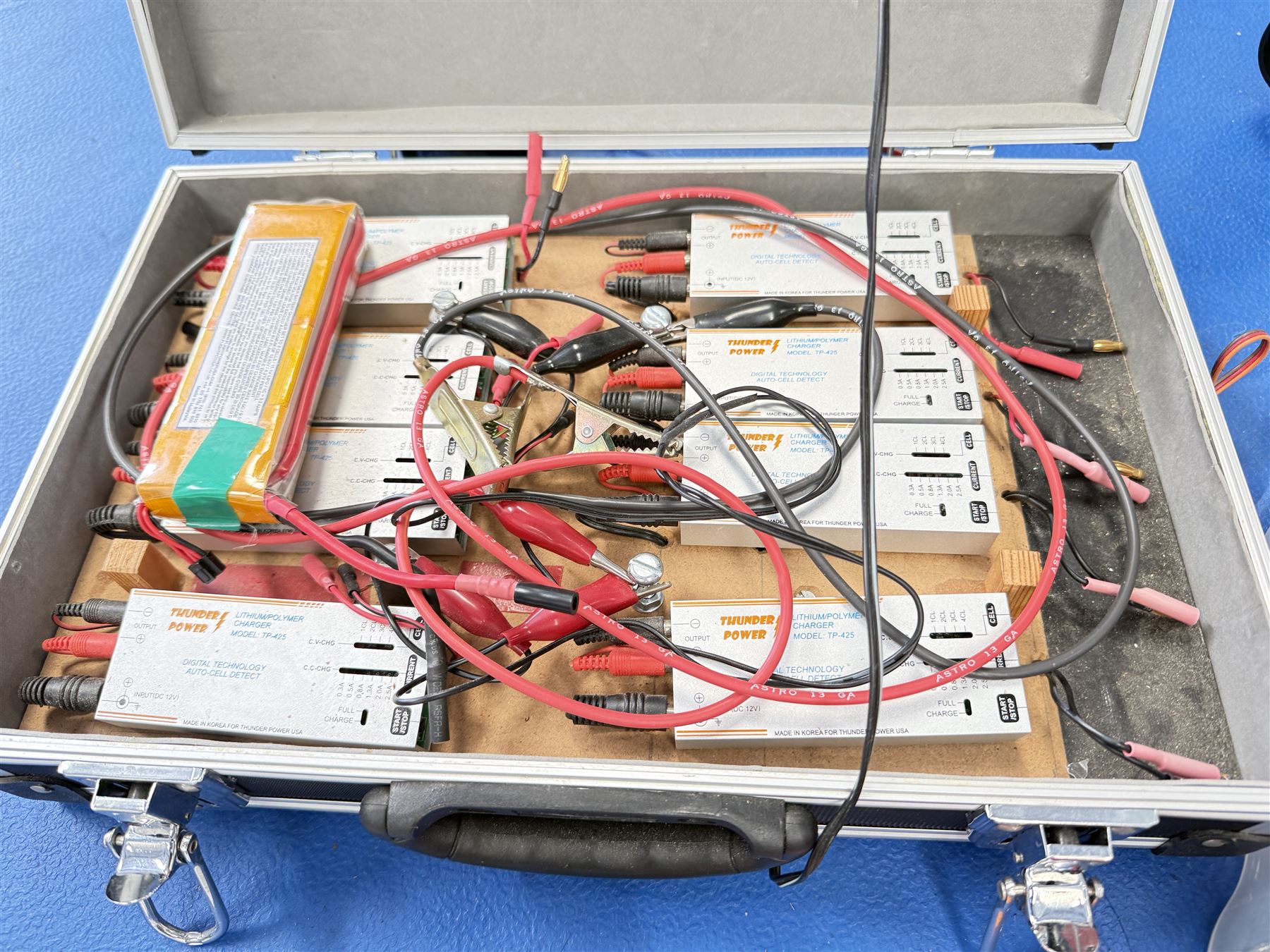 JR PCM9X II MacGregor 9 channel computer radio control system, case containing RC batteries, engines and other model parts