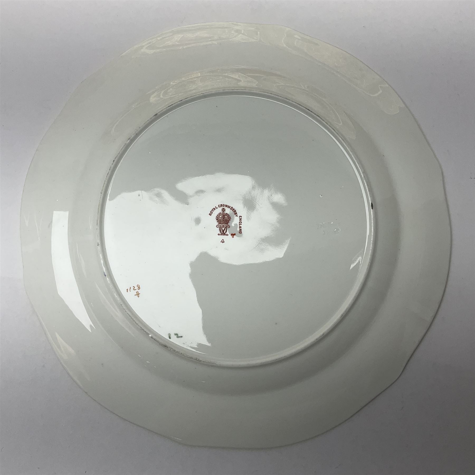 20th century Royal Crown Derby Imari 1128 pattern plates, comprising four side plates and three smaller examples, with printed and painted marks beneath, including illustration date codes for 1918 and 1920, and Roman numeral date code for 1979, larger examples D18cm, smaller D15cm, (7)
