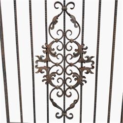 Victorian wrought iron vineyard gate, with ornate scrollwork and foliate acanthus leaf decoration, shaped cresting and central decorative panel, finished in rustic black painted finish