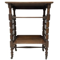 Late 19th century oak three-tier stand or bookcase, on turned supports with lattice sides, on turned feet with castors