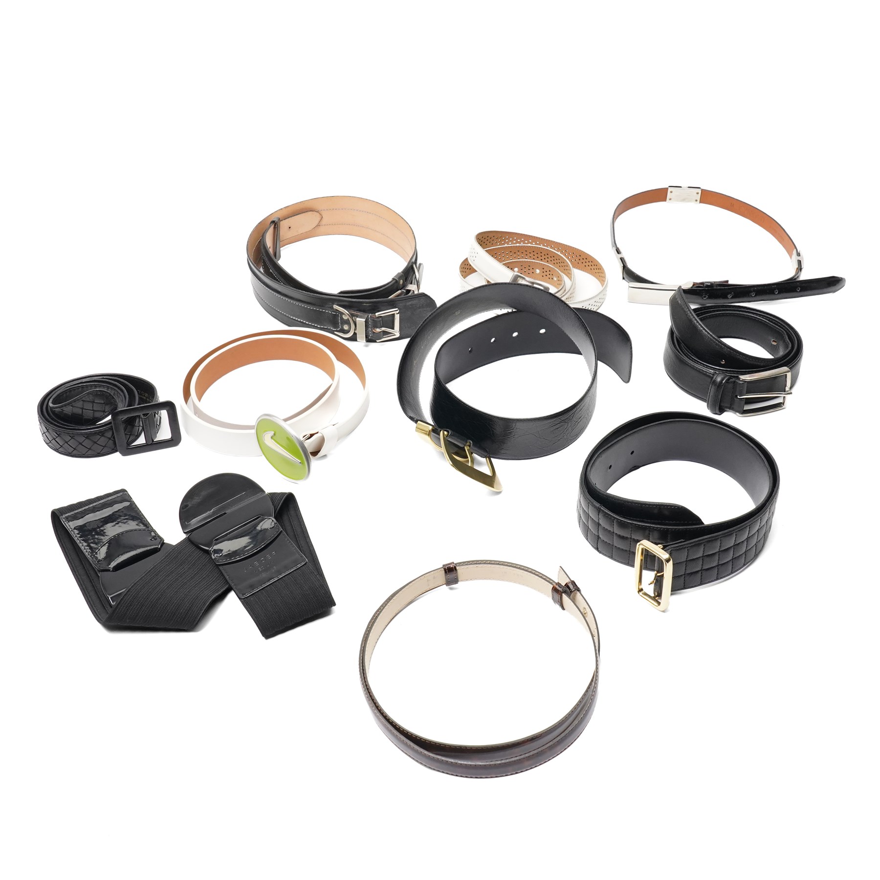 Collection of belts, including white Nike Golf leather belt with oval green and silver Nike swoosh buckle, white Nike leather belt in perforated pattern, black Aigner crocodile-embossed leather belt with large gold buckle, black Jaeger quilted leather belt with rectangular gold buckle, etc (10)