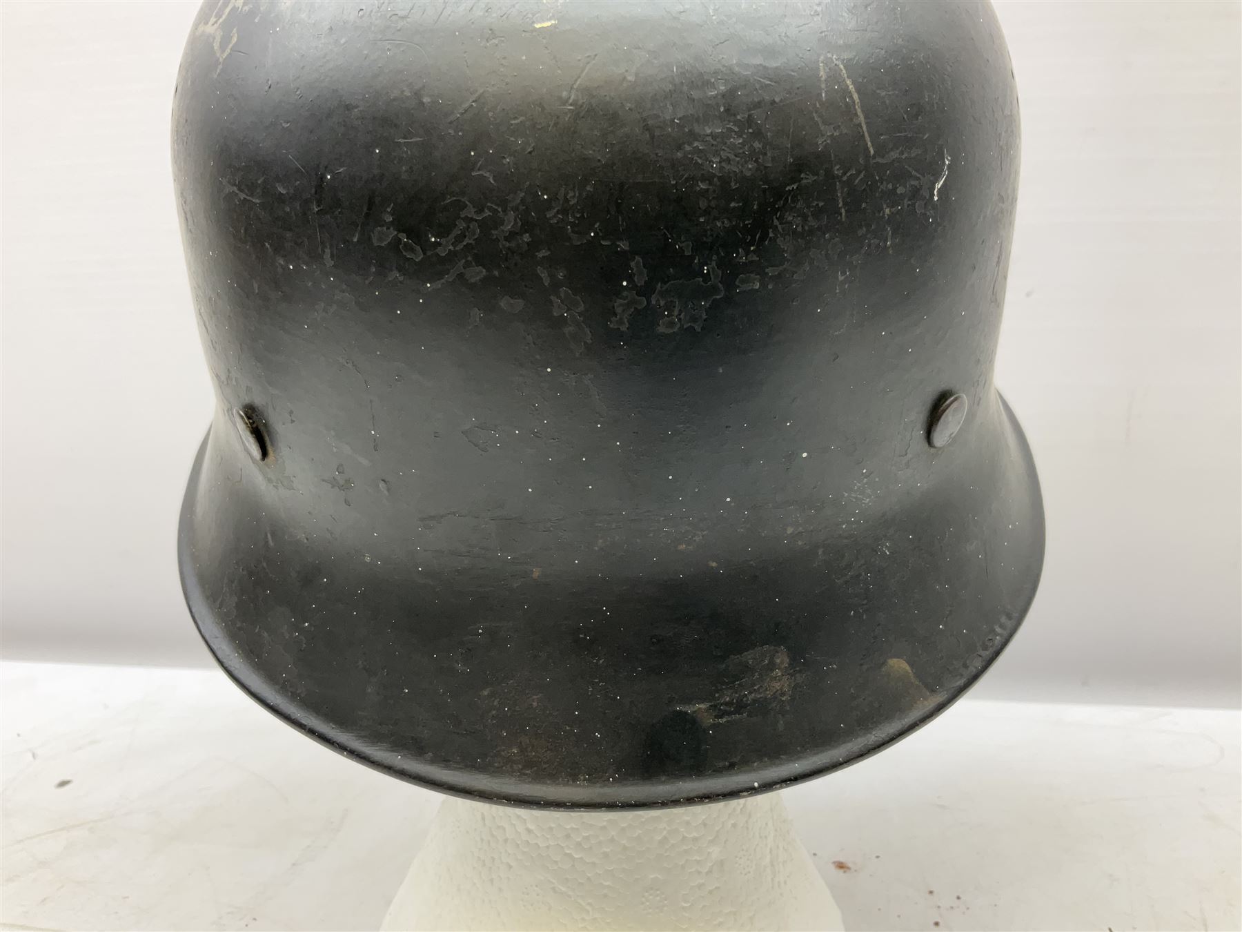 WW2 German steel combat helmet with eagle insignia to one side and U-724 to the other, leather liner marked No.56 and leather chin strap; indistinctly stamped to the skirt '*ahl'