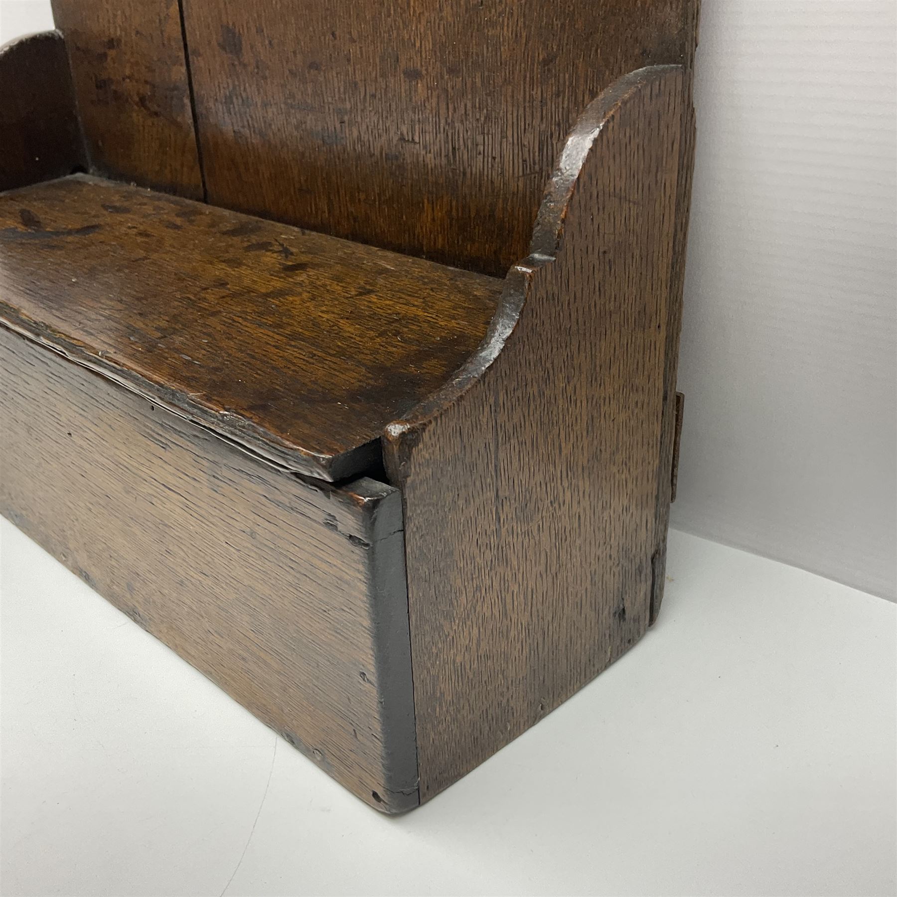 George III oak spoon rack and candle box, the rectangular backplate with shaped  pediment and two six aperture spoon racks, above a candlebox with hinged cover, with various brass spoons and a pair of brass candle snuffers, H56.5cm, W35cm, D14cm 