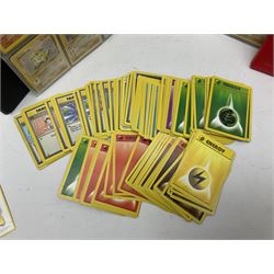 Collection of Pokemon trading cards, mostly 1999 Wizards Pokemon cards to include holo Charizard 4/102, first edition holo Machamp 8/102, further holographic cards; Dark Flareon 35/82 and Dark Vaporeon 45/82, cards from themed sets and 4th edition prints; 1998 Electronic Pokédex with cardboard boxes for themed decks Blackout, Overgrowth and Power Reserve Jungle, along with a large quantity of energy and trainer cards 
