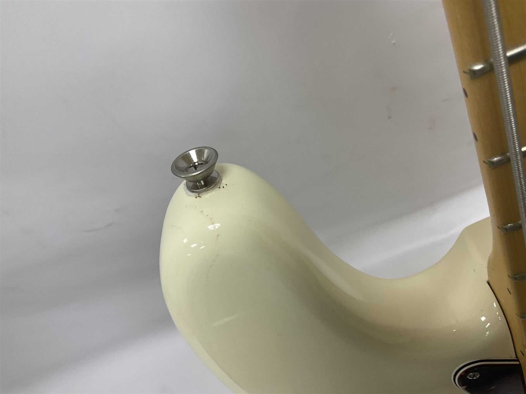 Fender Precision Bass guitar, in Olympic White finish with tortoiseshell effect scratchboard, serial no US15103092, in black Fender hard case with Fender strap and warranty card, guitar L116cm