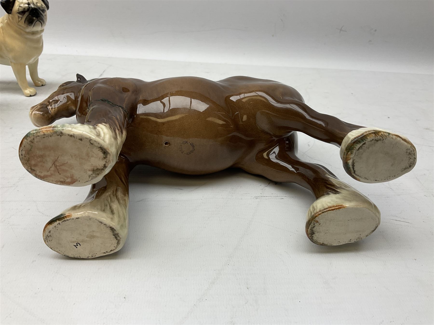 Three Beswick models comprising Hereford Bull no 949, 'CH Cutmil Cupie' Pug, and bay Shire horse, all with printed marks beneath