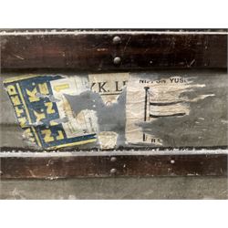 Early 20th century wood and metal bound zinc travelling trunk, hinged top with three clasps, decorated with period luggage labels