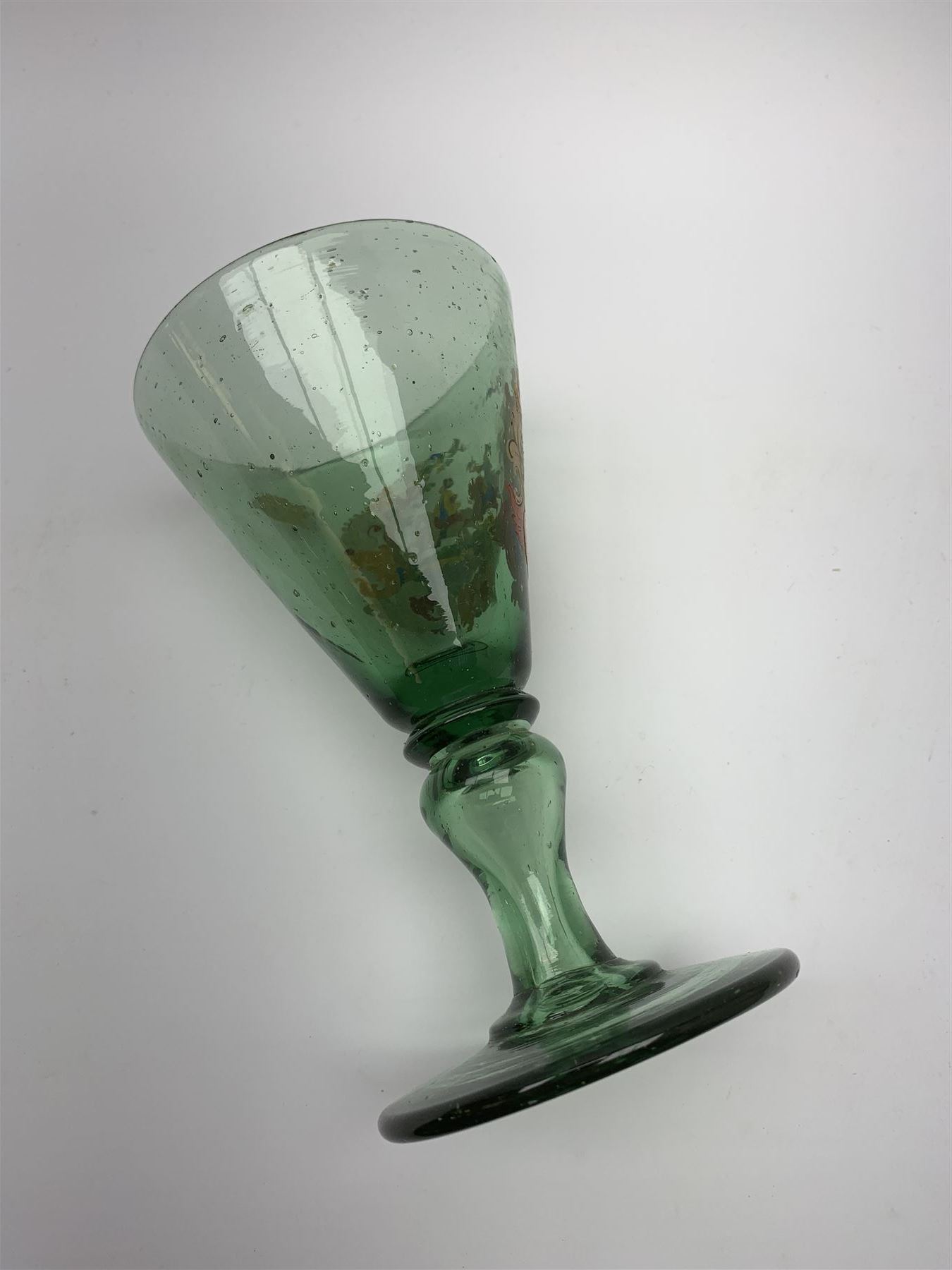 19th century bohemian green glass wine glass, the funnel bowl decorated in enamells with a Historismus hunting scene in the manner of Egermann & Lobmeyr, upon a baluster stem and circular foot, H14.5cm