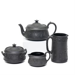 Four pieces of 19th century Wedgwood black basalt ware, c.1875, comprising larger and smal...