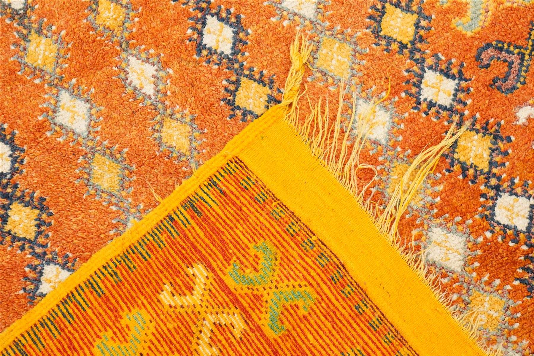 North Persian tribal rug, an orange field and six rows of lozenges, with a border of ram's horn motifs