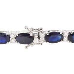 18ct white gold sapphire and diamond bracelet, twenty-three oval cut sapphires, each spaced by two round brilliant cut diamonds, stamped 750, total sapphire weight 14.785 carat, total diamond weight 0.88 carat