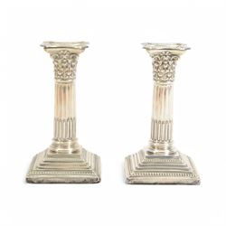 Pair of early 20th century silver Corinthian column candlesticks, upon square stepped filled bases, hallmarked Walter Latham & Son, Sheffield 1913, H16cm