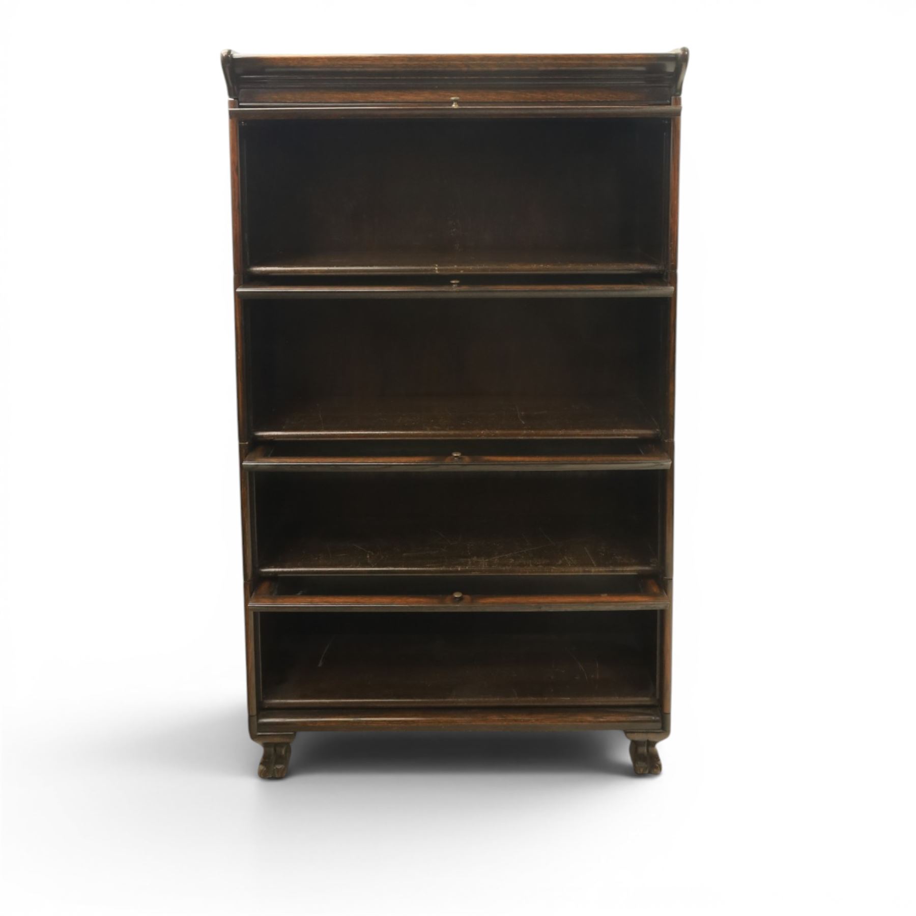Harris Lebus - oak barrister stacking bookcase, four tier design with glazed fronts with brass knobs, raised on claw and ball feet