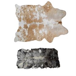 Skins/Hides: cow hide with brown and white dappled pattern together with another hide, pos...