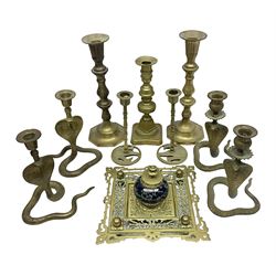 Brass inkstand, of square form, pierced, inset with blue and white ceramic inkwell to centre, together with a collation of brass candlesticks 