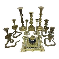  Brass inkstand, of square form, pierced, inset with blue and white ceramic inkwell to centre, together with a collation of brass candlesticks 