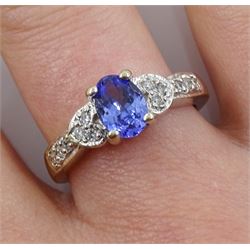 White gold oval tanzanite ring, with diamond set shoulders, stamped 14K