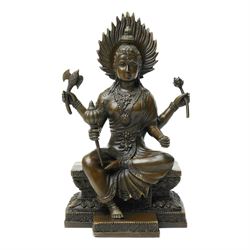 Contemporary bronze of a four armed Buddha, holding various symbolic items including a lot...