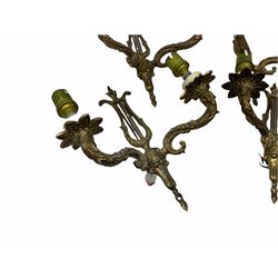 Set of four gilt metal wall sconces, each with lyre backs supporting twin scroll branches 