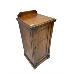 Late Victorian Aesthetic Movement walnut bedside cabinet, enclosed by single panelled door, with floral and geometric inlays