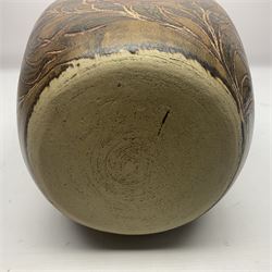 John Egerton (c1945-): studio pottery stoneware vase decorated with red birds in foliage, upon a brown ground, H34cm