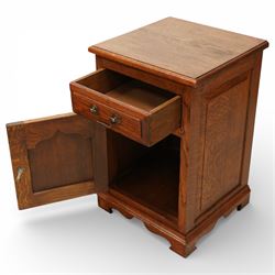 20th century pair of oak bed side cabinets, in the manner of Titchmarsh & Goodwin, plain rectangular tops over drawers fitted with brass handles and cupboard doors with carved arched panels, panelled sides and backs, raised on shaped bracket feet