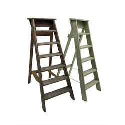 Early 20th century pine library or shop step ladder, seven tread (W45cm H135cm); together with another similar with painted laurel green finish (H135cm)