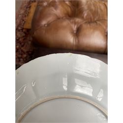 Chinese Kangxi famille verte plate, decorated with a bird perched upon a blossoming branch, within an iron red foliate border, D22cm