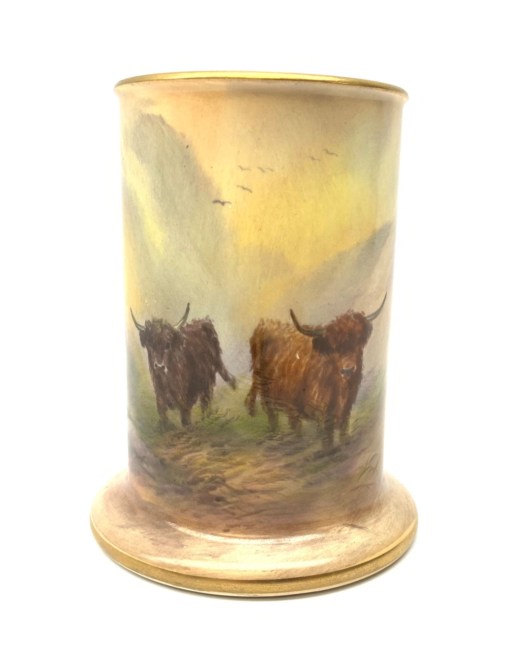 A Crown Devon Fieldings vase, of cylindrical form painted with a highland cattle scene and signed Cox, with printed marks beneath, H11.5cm