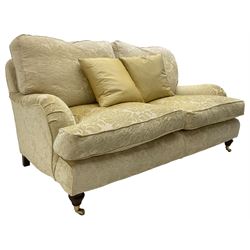 Multi-York - Howard shape two-seat sofa, upholstered in scrolling floral pattern loose covers, rolled arms, on turned front feet with brass cups and castors