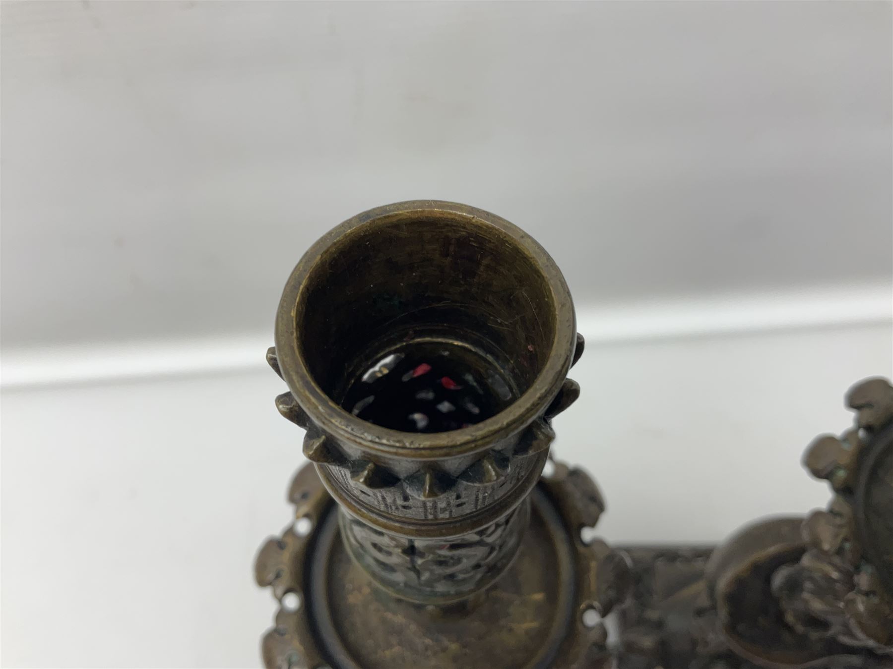 Pair of late 19th/ early 20th century brass candlesticks in the form of dolphins upon a stepped base with Fleur-de-lis design, H32cm 