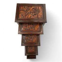 Carved hardwood nest of four occasional tables, each with rectangular top carved with figural scenes, on square supports with hoof terminals united by stretchers 