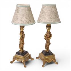Pair of brass table lamps, the central column modeled as a putti upon a square marble base raised upon four claw feet, H29cm