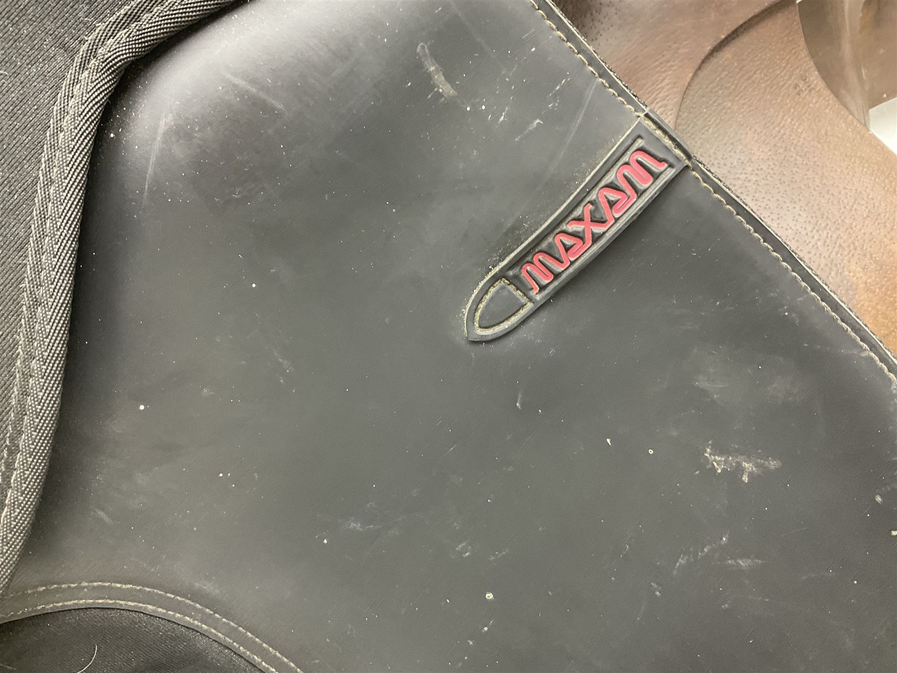 Collection of nine saddles, mainly havana leather to include a racing saddle and a Goodwin saddle, some with stirrups and leathers 