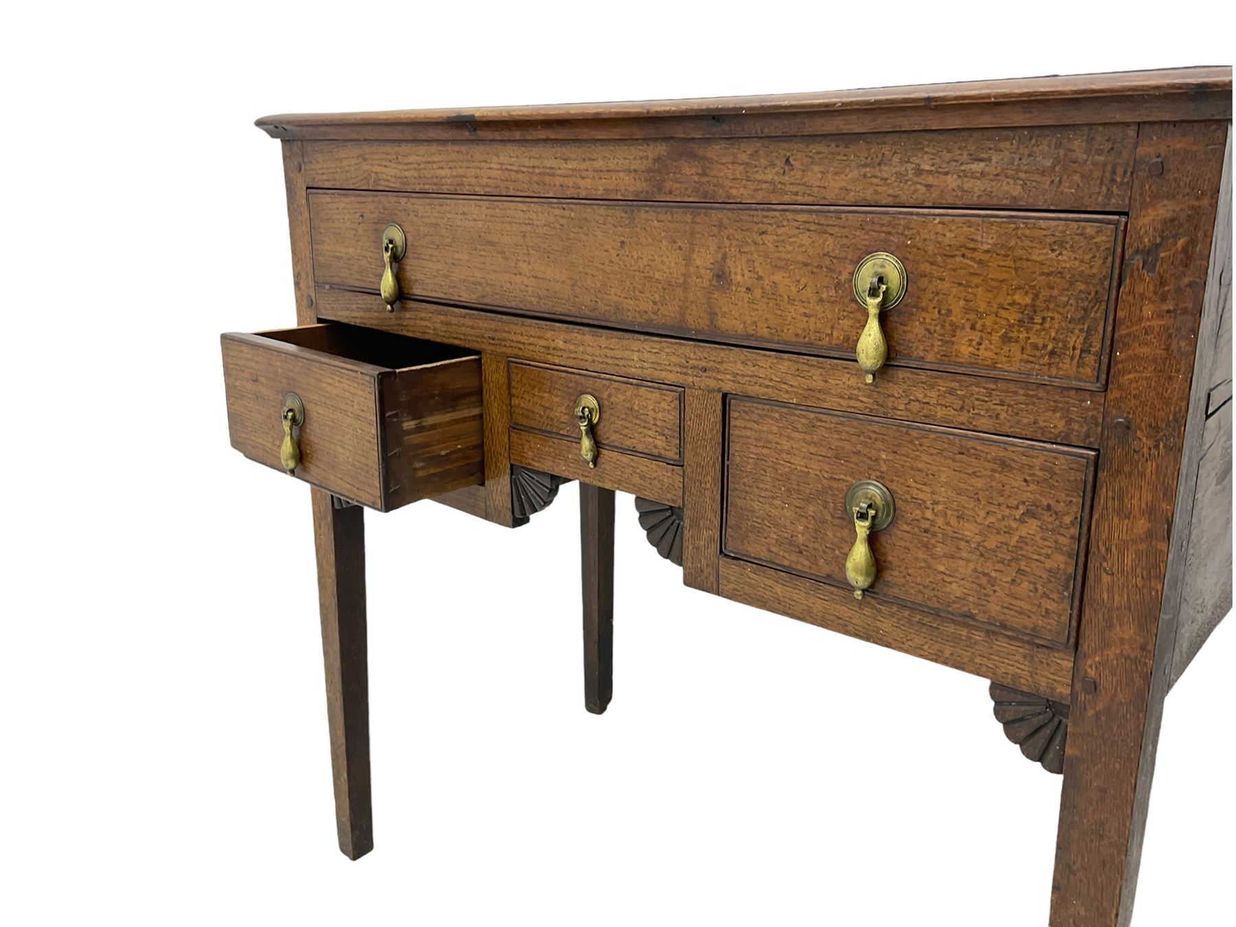 18th century Welsh oak lowboy, fitted with long drawer above three small drawers, square tapering supports, with fan carved corner brackets, circular plate and drop handles 