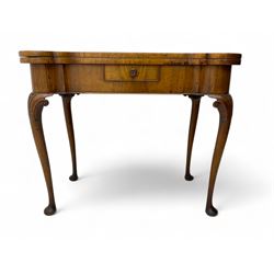 Georgian walnut fold-over card table, shaped rectangular top opening to reveal a baize-lined surface, supported by a concertina pull-out rear mechanism, frieze fitted with single drawer, raised on cabriole supports with foliate carvings terminating in pad feet