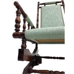 Early 20th century walnut framed American rocking chair, upholstered seat, back and arms