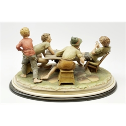 A large Capodimonte figure group, 'The Card Cheat', modelled as four card players, signed Merli, raised upon wooden base, L56cm.