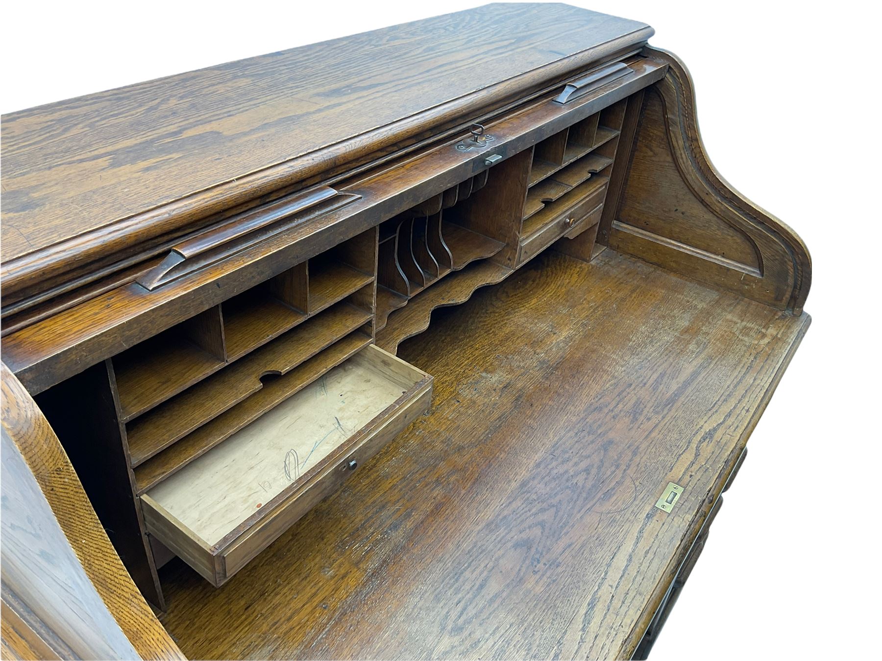Early 20th century oak roll top desk, the tambour roll enclosing fitted